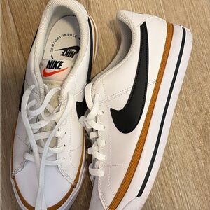 Nike White Leather Sneakers with Black Swoosh and Brown Accent
